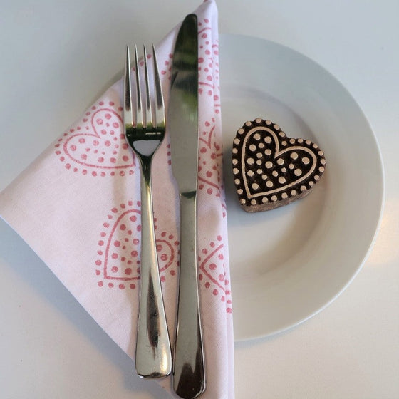 A hand block printed napkin printed with a Fabric Paint in a dotty heart design, block printed in Oxfordshire